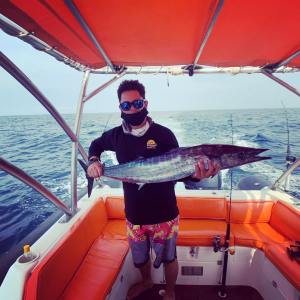 a person holding an orange boat on a body of water