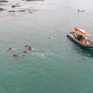 a group of people in a small boat in a body of water