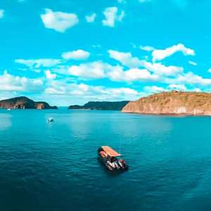 a large body of water with a mountain in the background