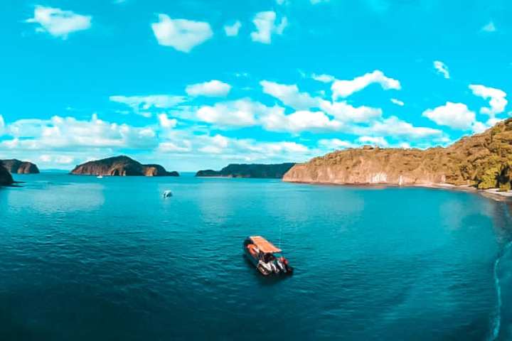 a large body of water with a mountain in the background