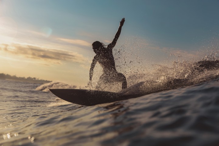 a man riding a wave on a surfboard in the ocean