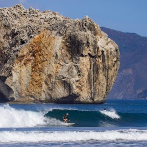 a large body of water with a mountain in the background